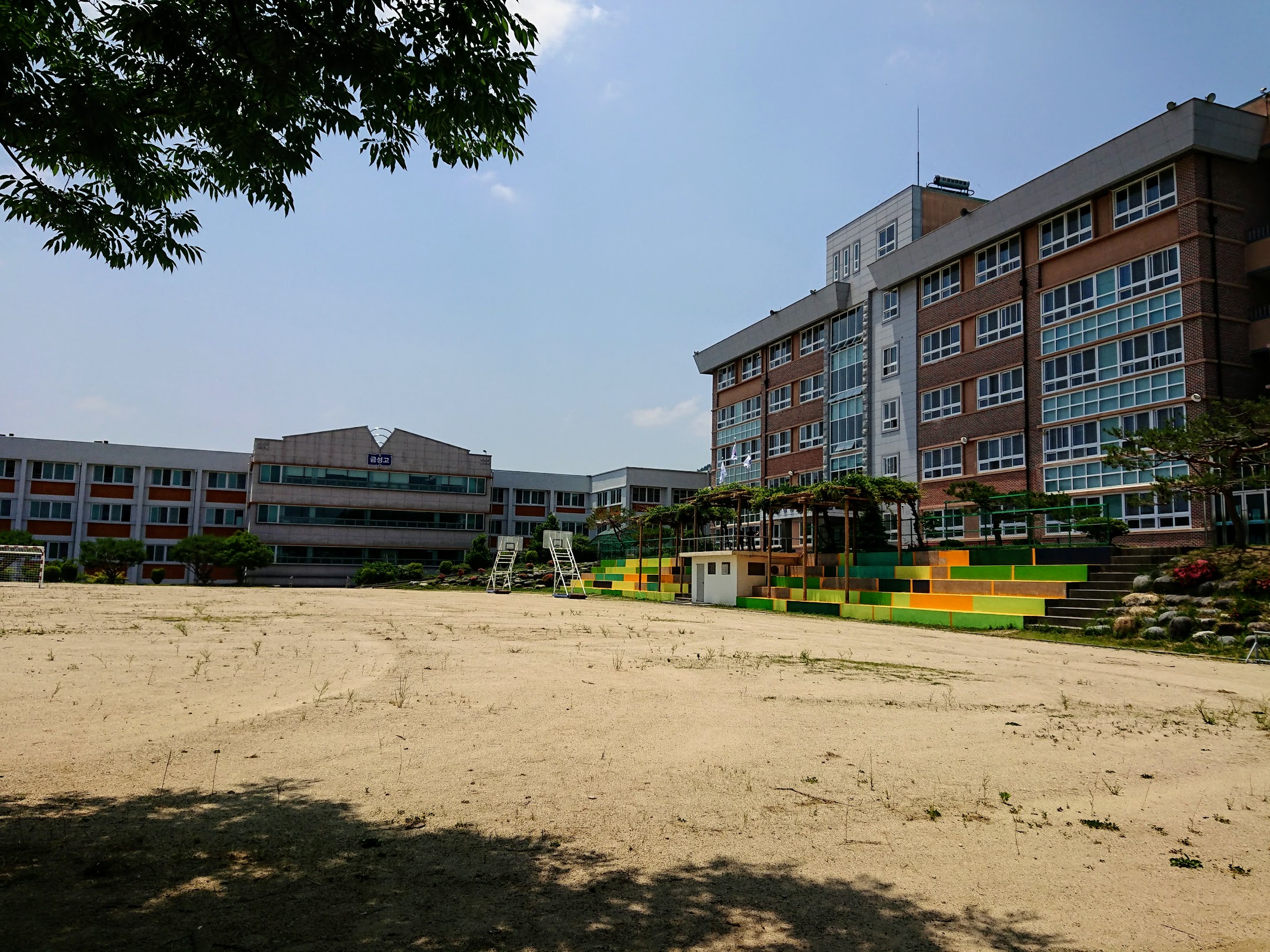 A picture of the school I taught at in Naju on a sunny day. The bleachers feature a newly painted mural in spring colors.